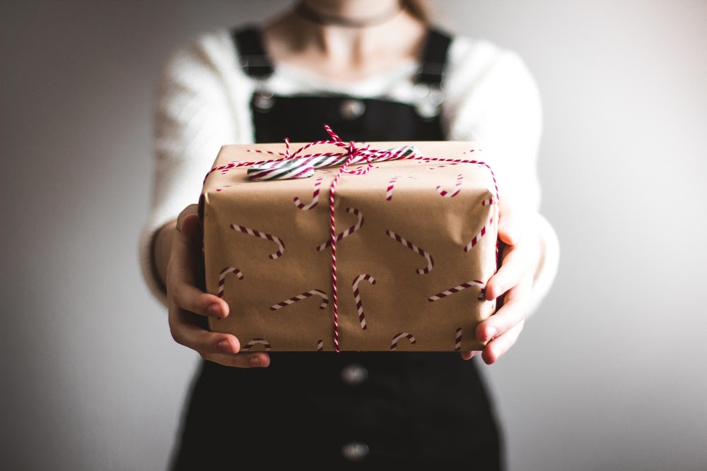 Person holding out a gift