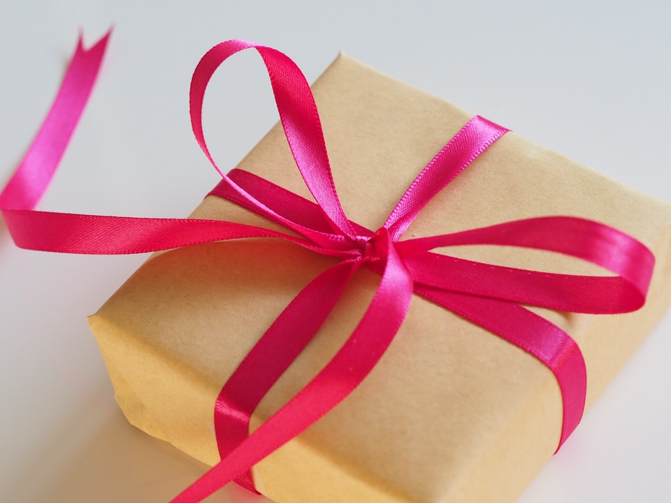 Red ribbon on gift wrapping on company-branded merchandise