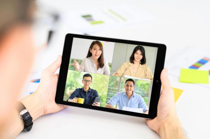 Tablet with a virtual remote meeting on screen