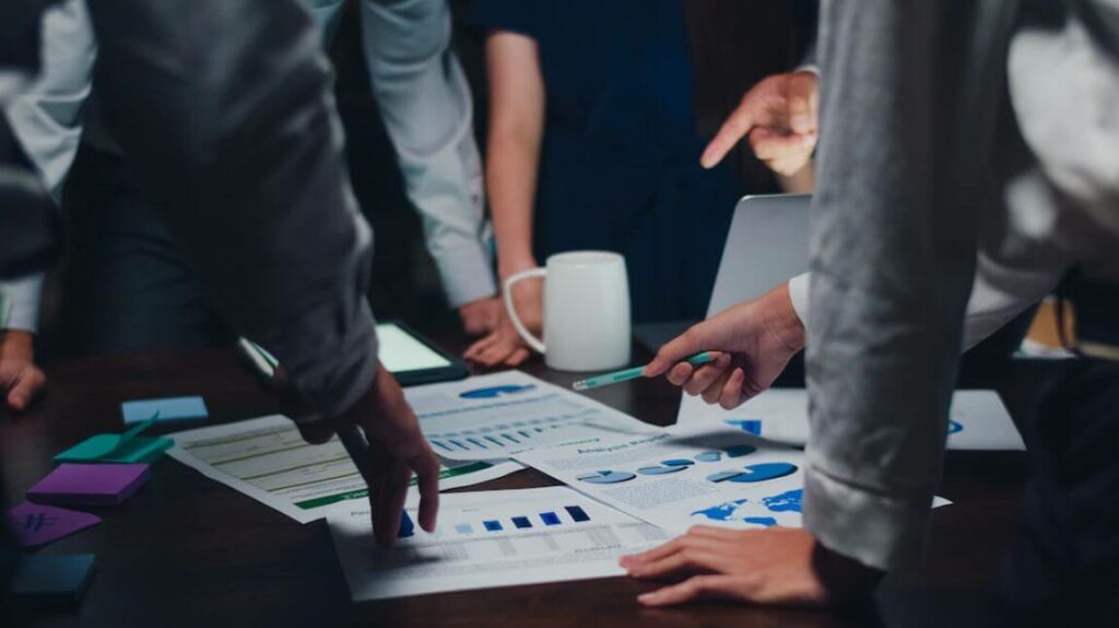 Group of people studying the results of the company culture implementation through branding