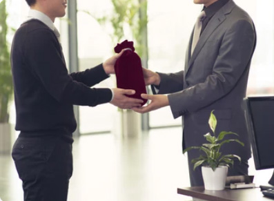 A man giving a corporate gift
